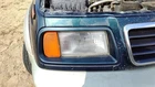 96-97 Suzuki Sidekick Passenger Right Headlight Trim Surround Panel Green Sort Used. Price: $135.31.
