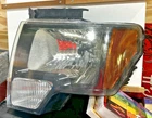 Tyc Genuine Ford 2010-2014 F-150 Headlight Assembly W/ Black Trim Left Used. Price: $39.99.